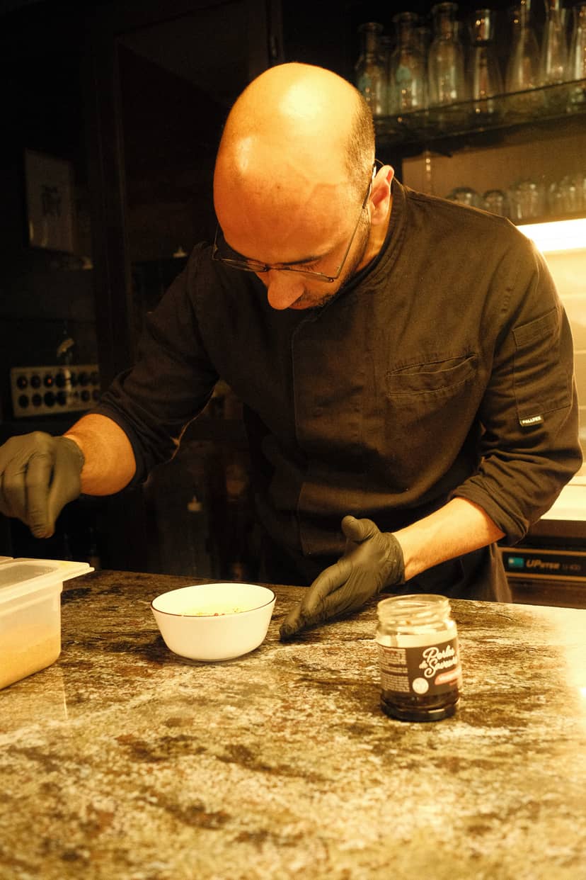 Chef preparing dish at SHOKUDO Izakaya, a Japanese izakaya restaurant in Zurich, Switzerland.